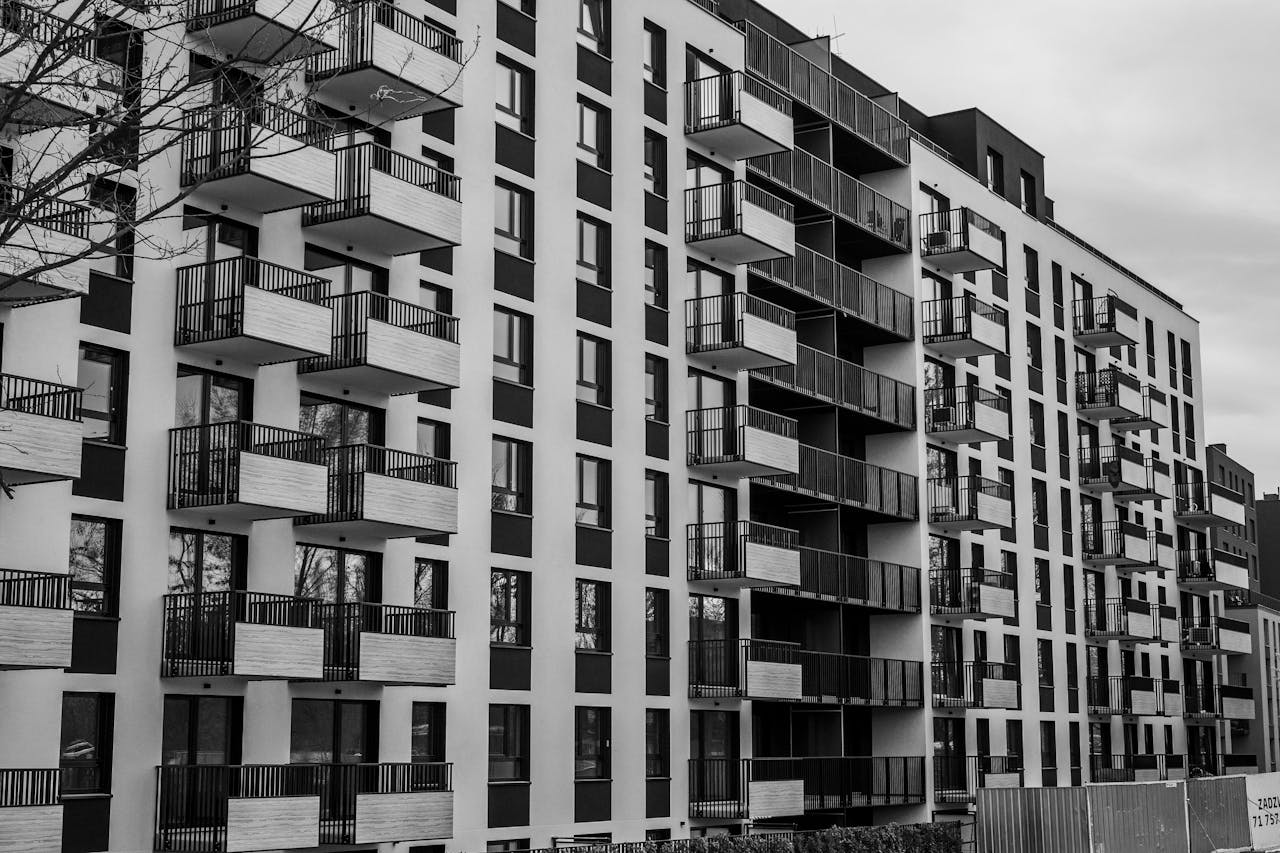 Mastering the First Impression: Your intriguing post title goes here Black and white photo of a contemporary apartment building with multiple balconies.